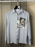 Blue and white striped shirt with a graphic patch